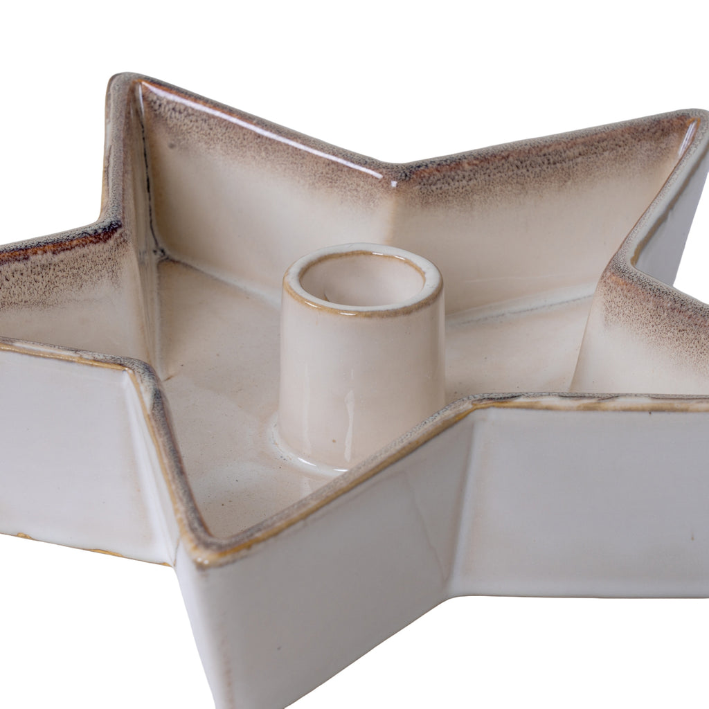 Close-up of the star candle holder's raised cylindrical socket and folded points, showing the glossy surface, brown-grey speckling and amber rim.