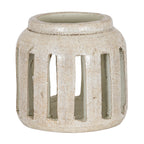Rounded cream candle holder with brown speckles, a broad raised rim and tall rectangular openings around the body.