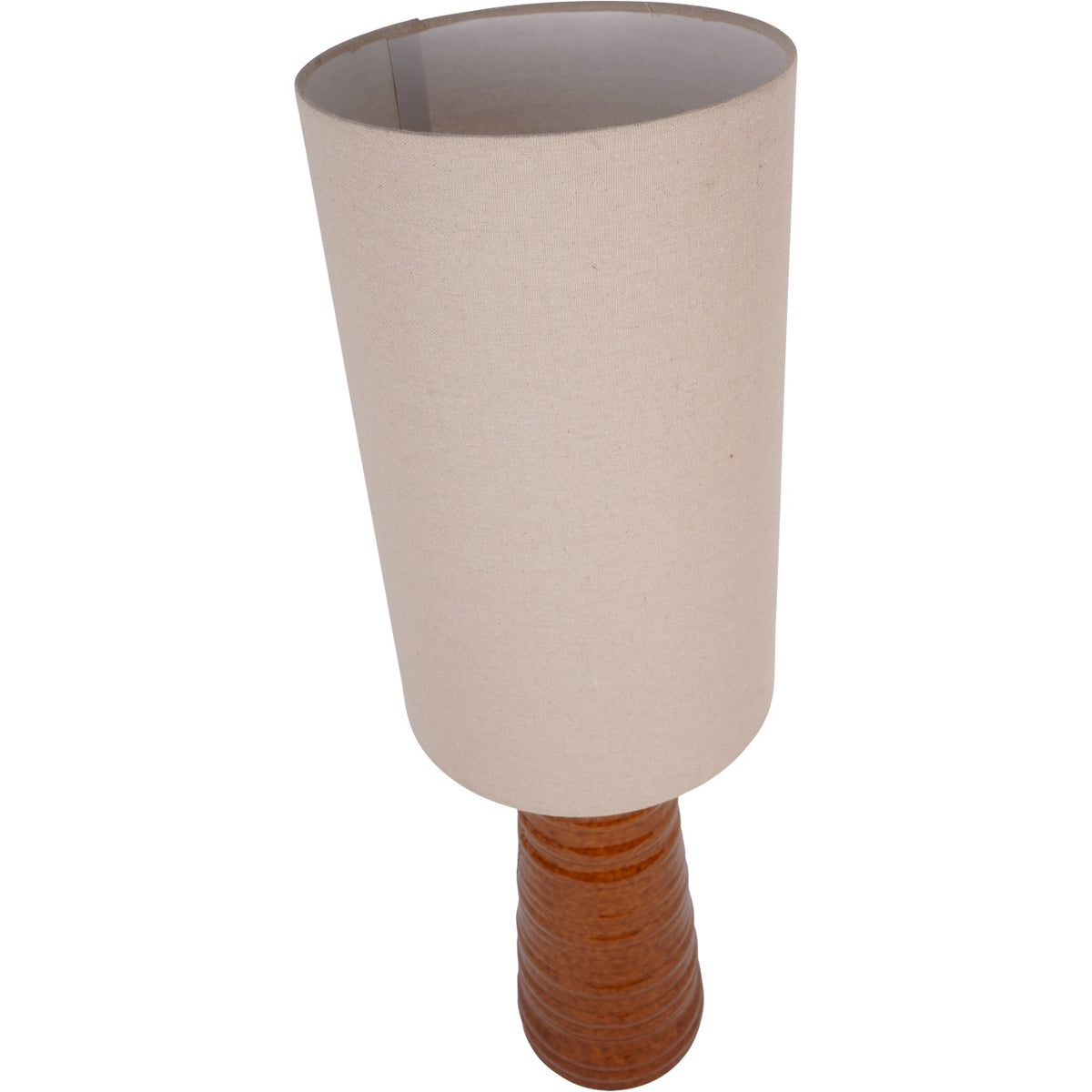 Elevated angled view showing the open top of the ivory woven shade and the grooved ceramic base below.