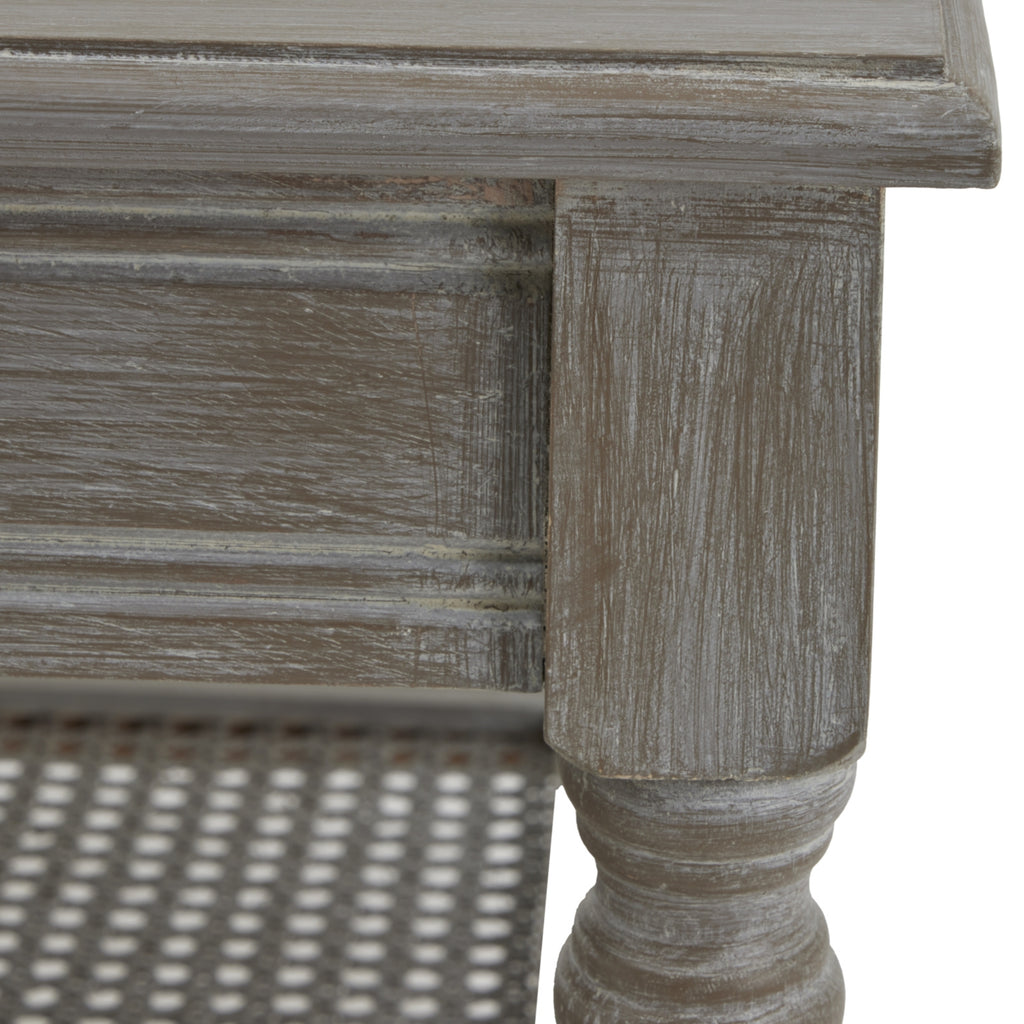 Close-up of the tabletop corner and upper leg, showing pale streaks across the grey-brown finish and outlined edges beneath the top.