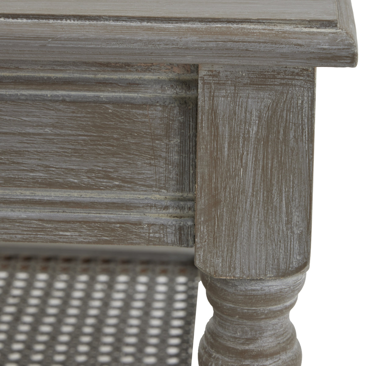 Close-up of the tabletop corner and upper leg, showing pale streaks across the grey-brown finish and outlined edges beneath the top.