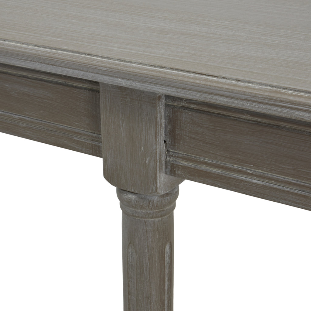 Close-up of the console's grey tabletop edge, moulded apron and the ringed detail at the top of a leg.