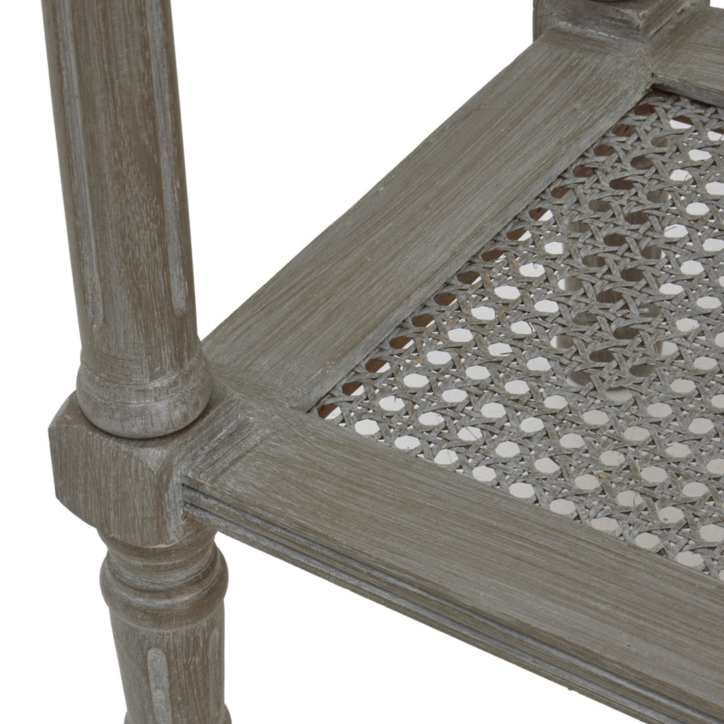 Close-up of a console table leg and lower shelf corner, showing pale streaks in the finish, moulded edging and the open geometric weave.
