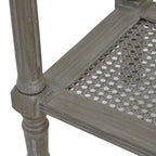 Close-up of a console table leg and lower shelf corner, showing pale streaks in the finish, moulded edging and the open geometric weave.