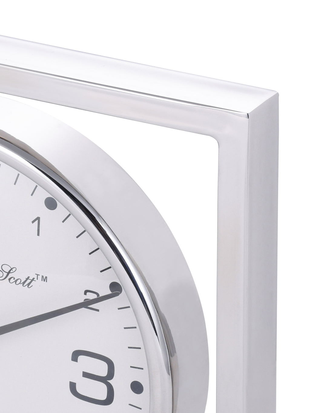 Close-up of the polished upper corner of the square clock frame beside the curved dial rim.