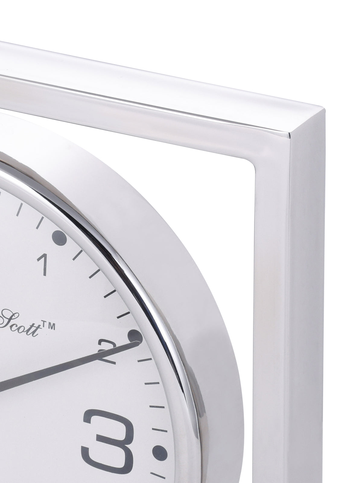Close-up of the polished upper corner of the square clock frame beside the curved dial rim.