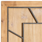 Close-up of the clock's upper-left corner, showing the honey-brown surround, grain-patterned face and dark numeral framework.