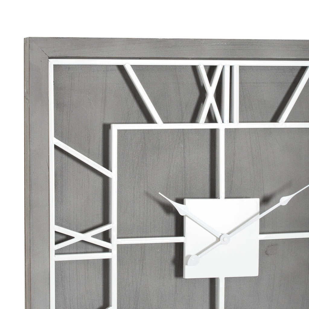 Close-up of the clock's grey wood-look texture, white numeral framework and square centre beneath the decorative hands.