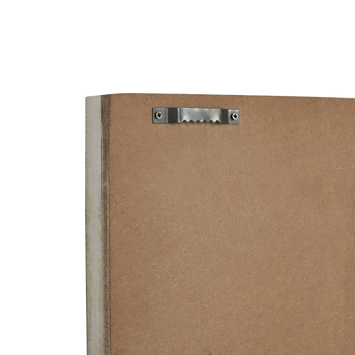 Close-up of the clock's brown rear backing and whitewashed frame edge, with a silver-coloured sawtooth hanger secured by two screws.