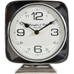 Straight-on front view of the square silver clock, showing shaped black hands and enlarged numerals at twelve, three, six and nine.