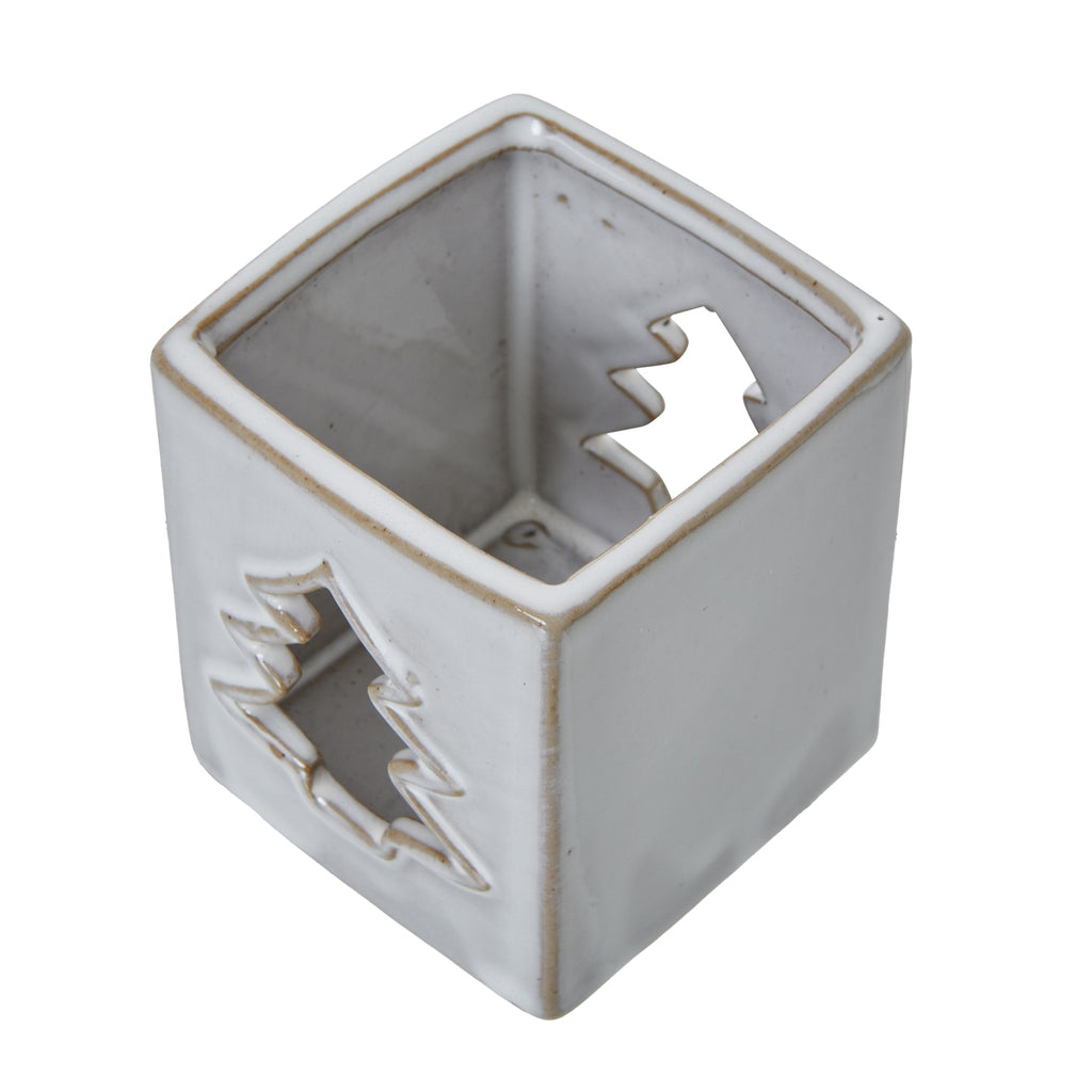 View down into the square candle holder showing the tan-lined rim, interior and tree-shaped openings on opposite faces.