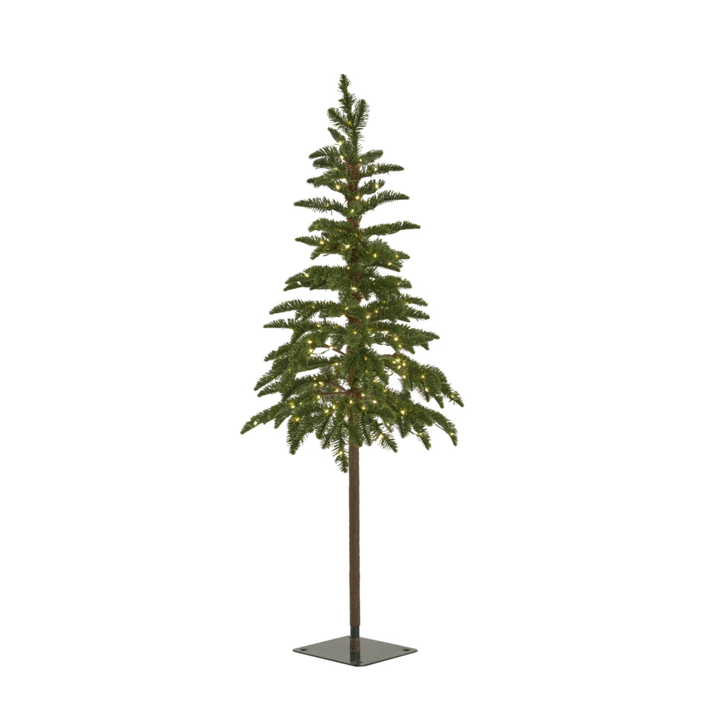 Artificial woodland Christmas tree shown with warm lights among its green branches above an exposed trunk and square dark base.
