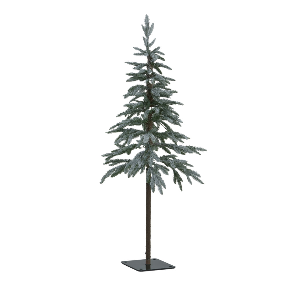 Full view of a snow-dusted green artificial tree with layered branches, an exposed brown lower trunk and a dark square base with four holes.