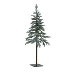 Full view of a snow-dusted green artificial tree with layered branches, an exposed brown lower trunk and a dark square base with four holes.