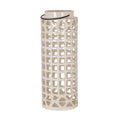 Tall glossy cream lantern with rows of square cut-outs, triangular openings at the top and base, and a dark handle resting beneath its open neck; no candle is visible.