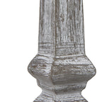 Close-up of the lamp's lower column, showing white surface markings across the grey-brown finish and its shaped contours.