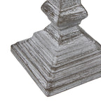 Angled detail of the stepped square lamp foot, with rubbed white highlights outlining its layers.