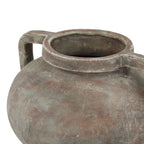 View from above showing the vase's open mouth, thick rolled rim and pale weathering over a terracotta-brown surface.