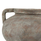 Close-up of the left squared handle and curved shoulder, showing mottled grey-white markings across the brown finish.