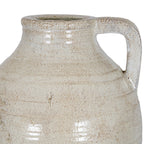 Close-up of the squared loop handle and curved shoulder, showing beige surface markings and sheen.