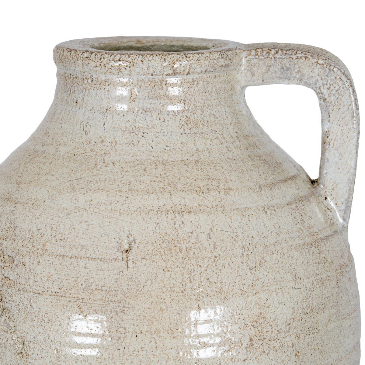 Close-up of the squared loop handle and curved shoulder, showing beige surface markings and sheen.