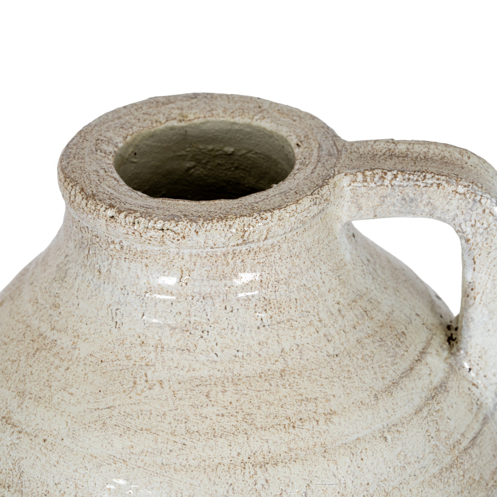 View from above of the jug's open neck, thick mottled rim and upper handle.