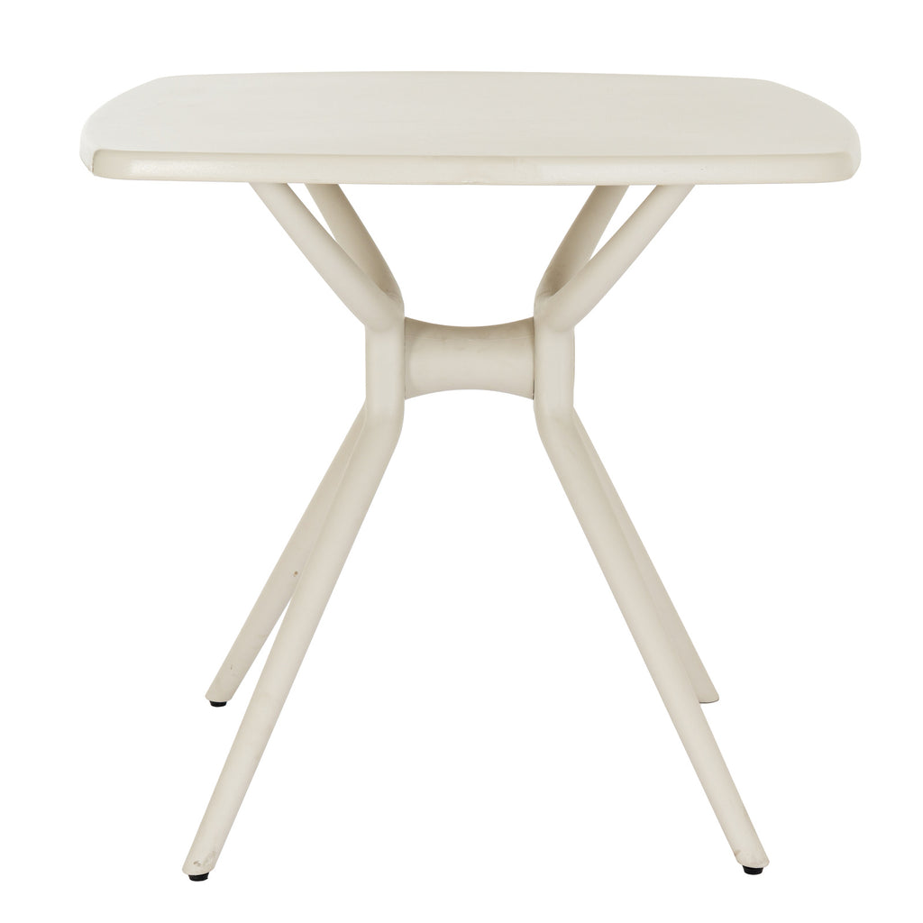 Side view of the putty-toned dining table, showing the horizontal central hub between curved supports and the legs angling outwards.