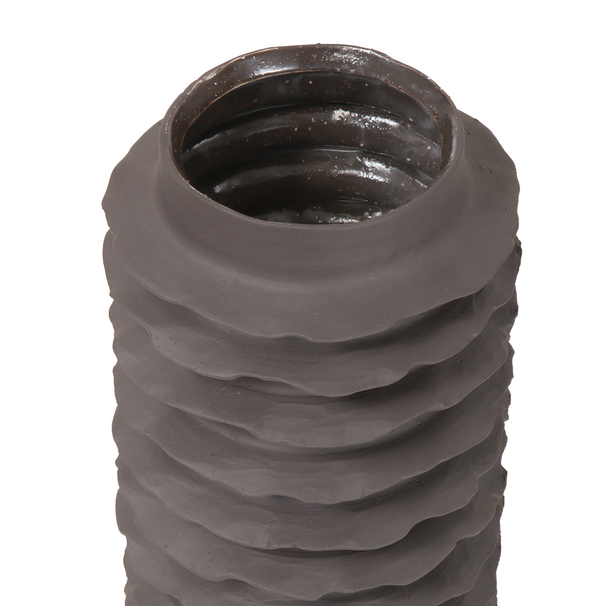 View into the vase opening, with a reflective dark interior above the matte ribbed exterior.