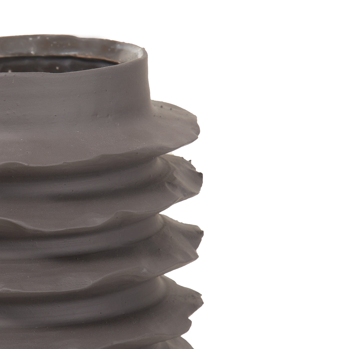 Close-up of the vase neck and upper ribs, showing their uneven edges and matte brown surface.