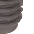 Detail of the lower stacked ribs and plain base of the dark brown vase.