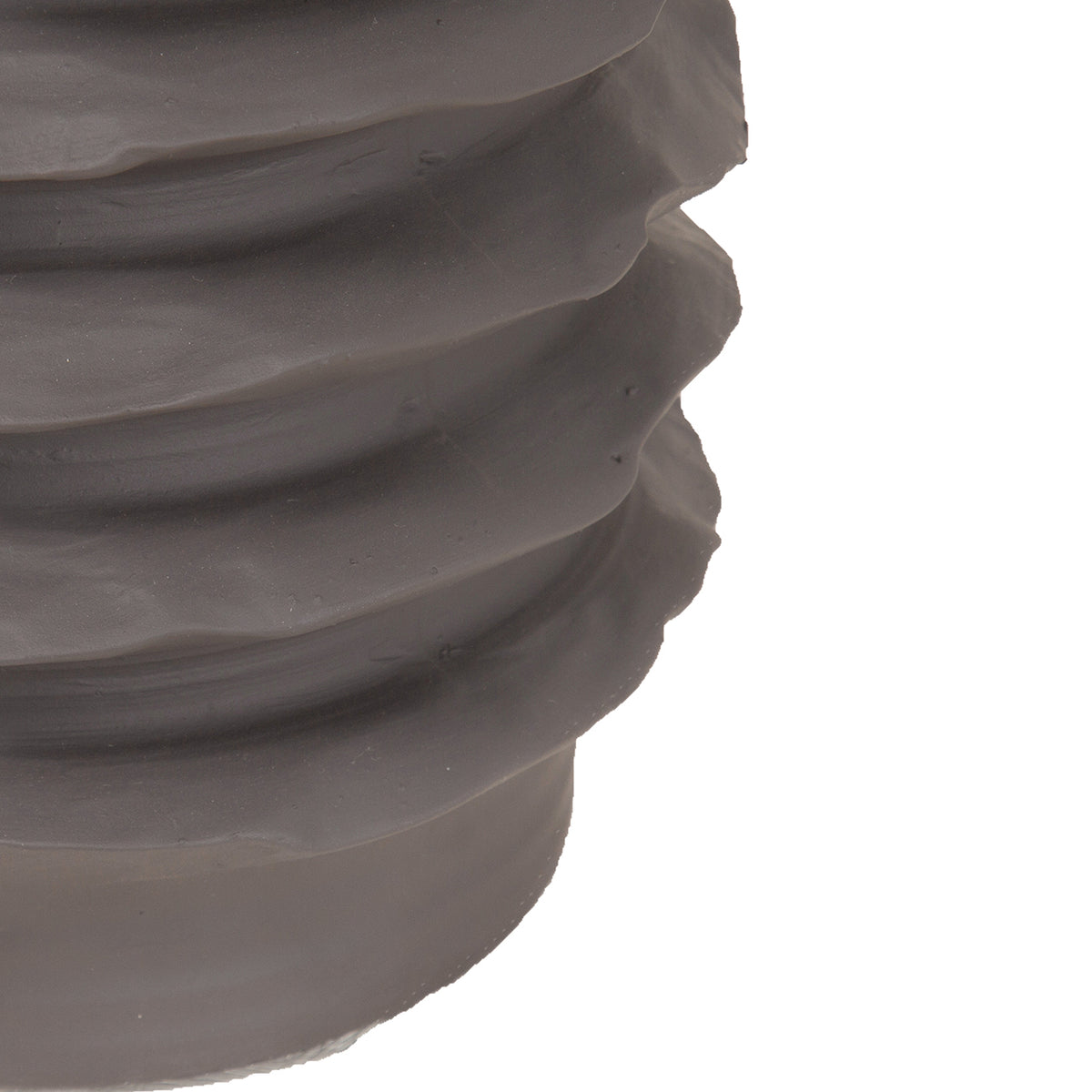 Detail of the lower stacked ribs and plain base of the dark brown vase.