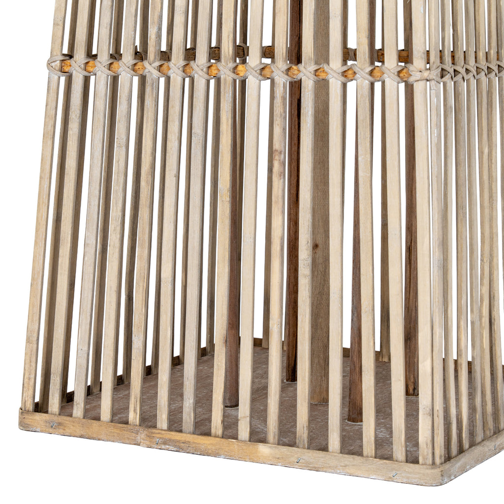 Detail of the lantern's lower slats, crossed binding band and square base, with internal upright supports visible behind.