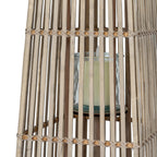 Close-up through the lantern's slats showing the transparent cylindrical holder, a pale candle and crossed bindings around the section joins.