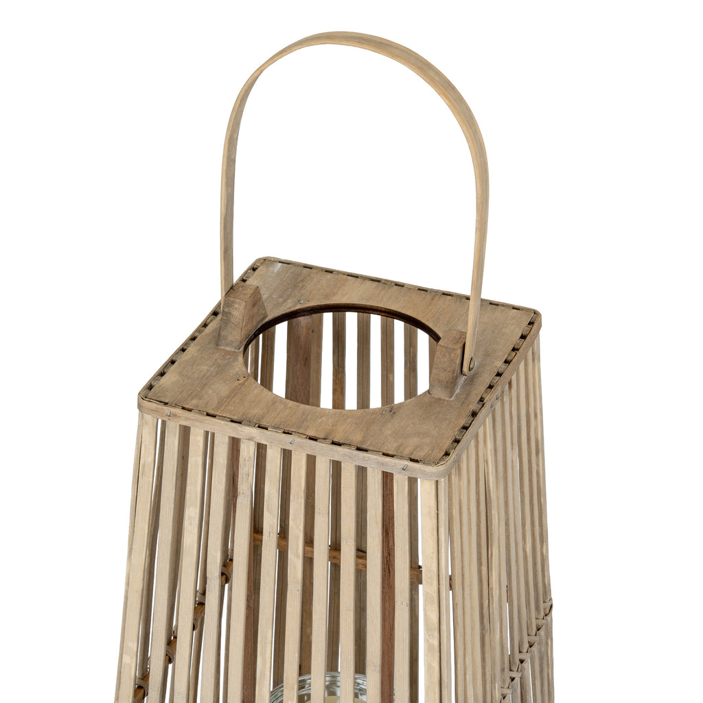 Angled close-up of the lantern's arched handle and square top with a circular opening above the vertical slats.