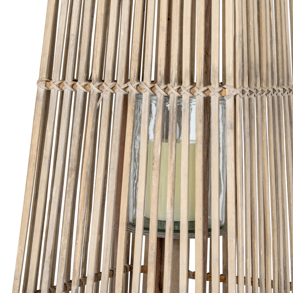 Central clear cylindrical holder with a pale candle visible behind the lantern's slats and crossed binding band.