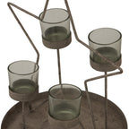 Angled close-up of the four grey-green votive cups, their round supports and the speckled, weathered-looking star outline above the raised tray.