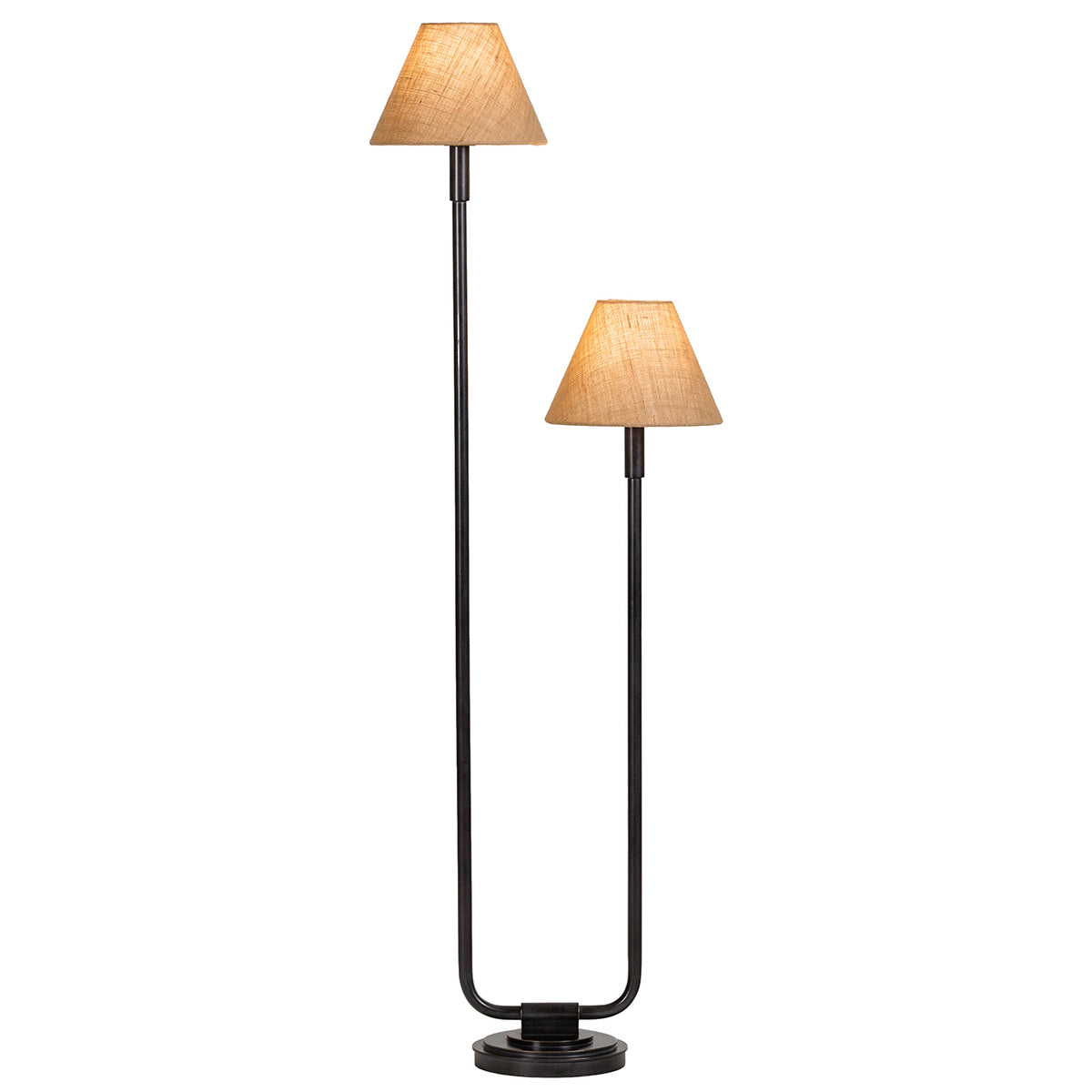 Twin floor lamp with both natural fabric shades illuminated, showing their woven texture above the dark staggered stems.