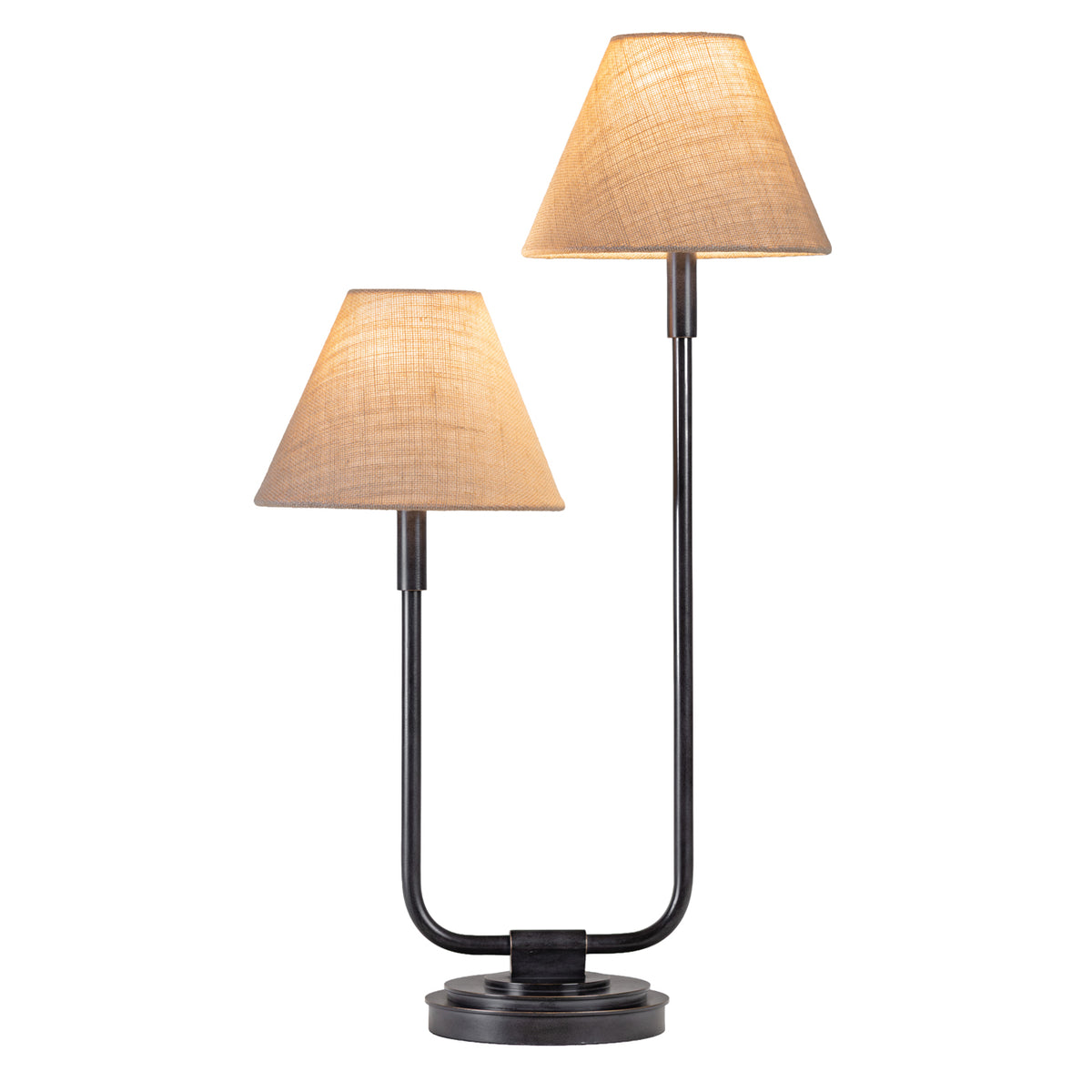 Twin table lamp illuminated against a white background, with light glowing through two woven fabric shades on staggered stems.