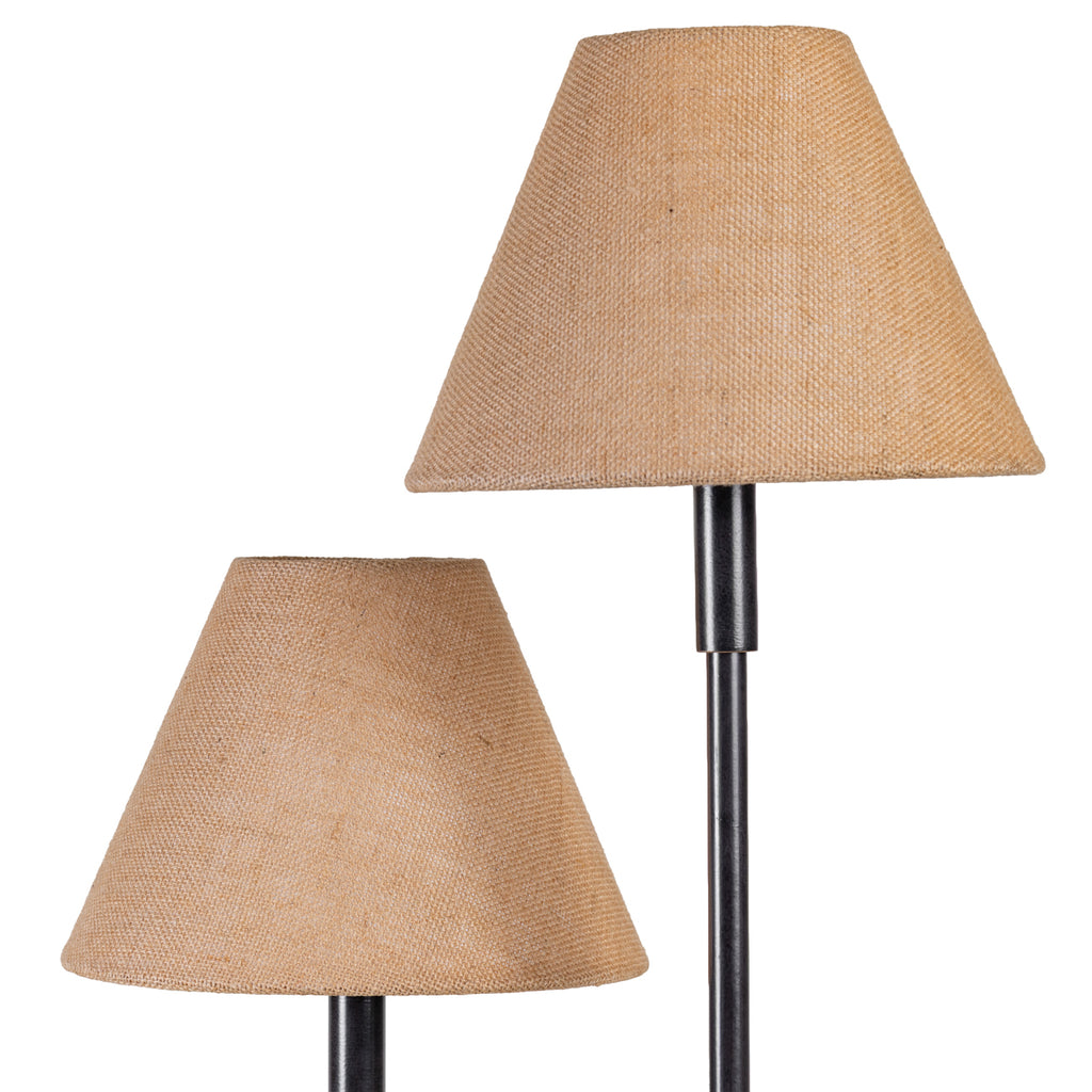 Detail of two natural-toned tapered lampshades, showing their woven fabric texture and different heights above the dark stems.
