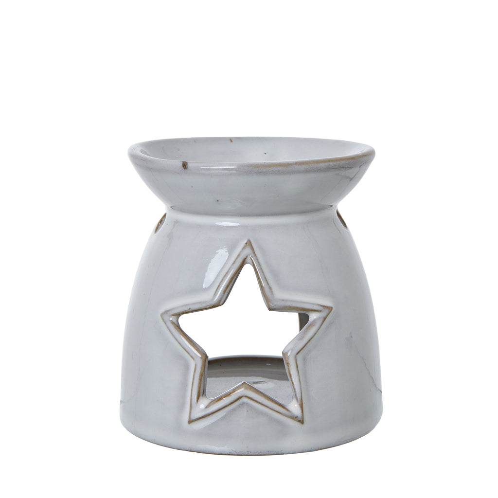 Front view of an off-white wax warmer with a large outlined star opening and a shallow bowl at the top.