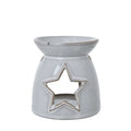 Front view of an off-white wax warmer with a large outlined star opening and a shallow bowl at the top.