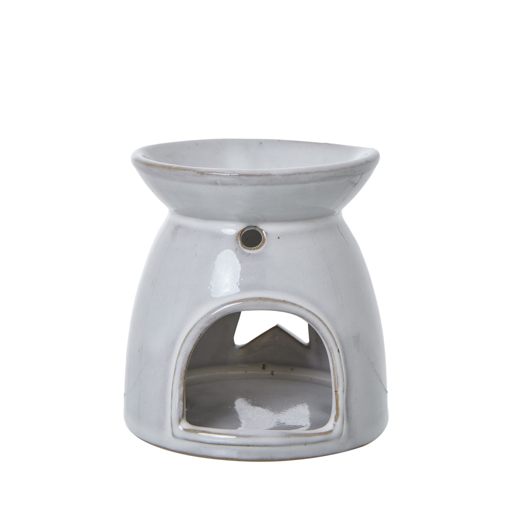 Rear view of the glossy off-white warmer showing an arched opening, a small round hole above it and the star visible through the hollow body.