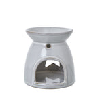 Rear view of the glossy off-white warmer showing an arched opening, a small round hole above it and the star visible through the hollow body.