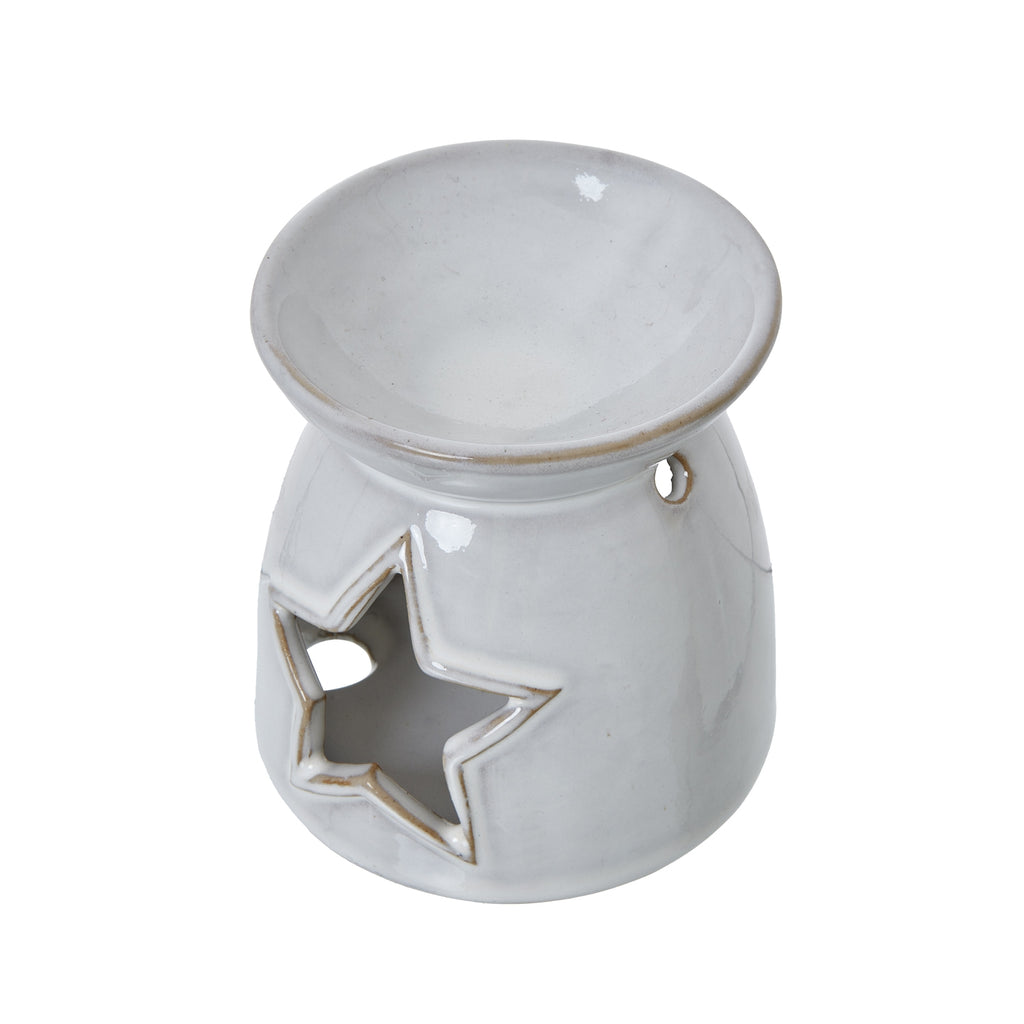 Angled view from above showing the warmer's shallow circular bowl, brown-toned rim, star opening and small round side hole.