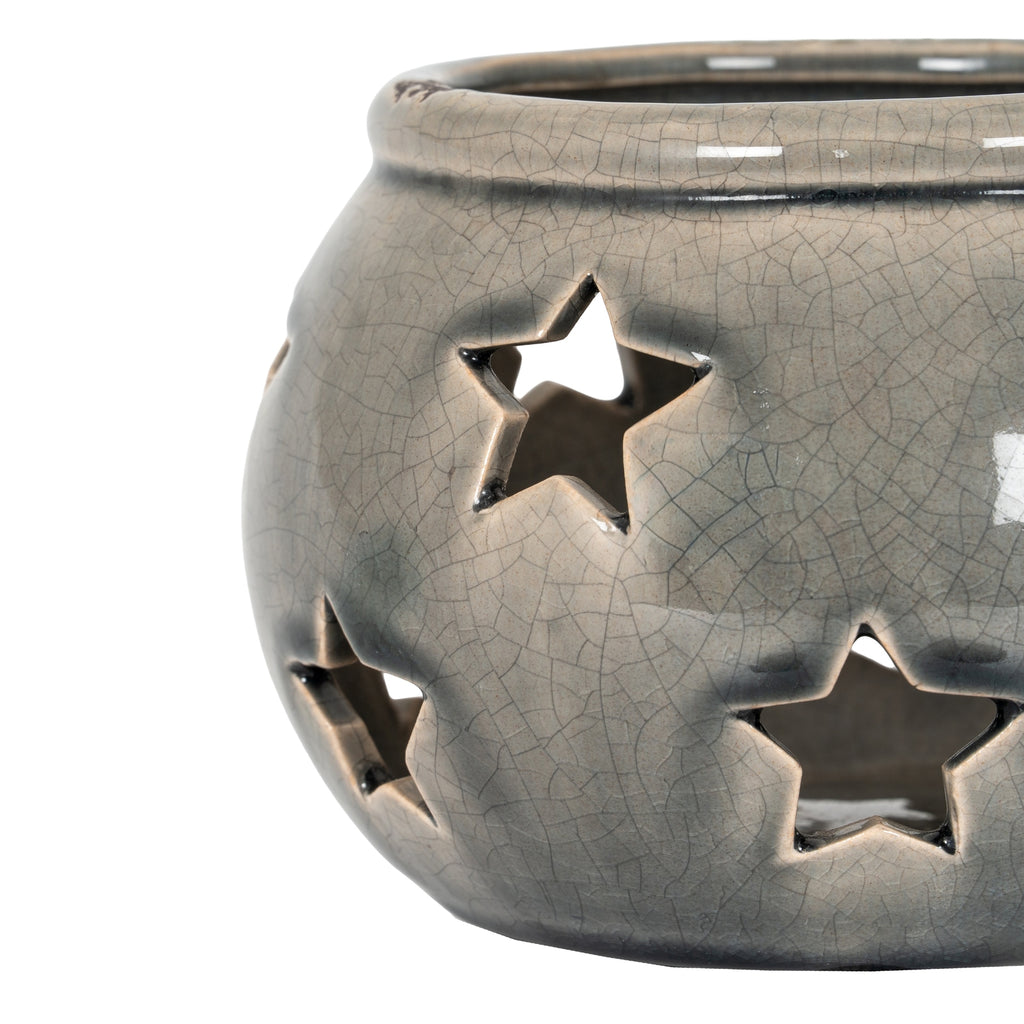 Close-up of the lantern's star-shaped openings and glossy grey-beige crackle pattern, with dark shading beneath the rim.