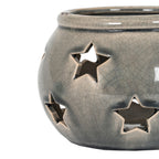Close-up of the lantern's star-shaped openings and glossy grey-beige crackle pattern, with dark shading beneath the rim.