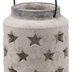 Close-up of the lantern's star-shaped openings, uneven pale surface and dark grey neck, with the open top and sides of the black handle visible.