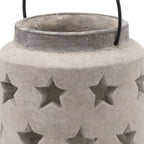 Close-up of the lantern's open neck, darker grey rim and star-shaped openings in the textured pale surface, with the sides of the black handle visible.