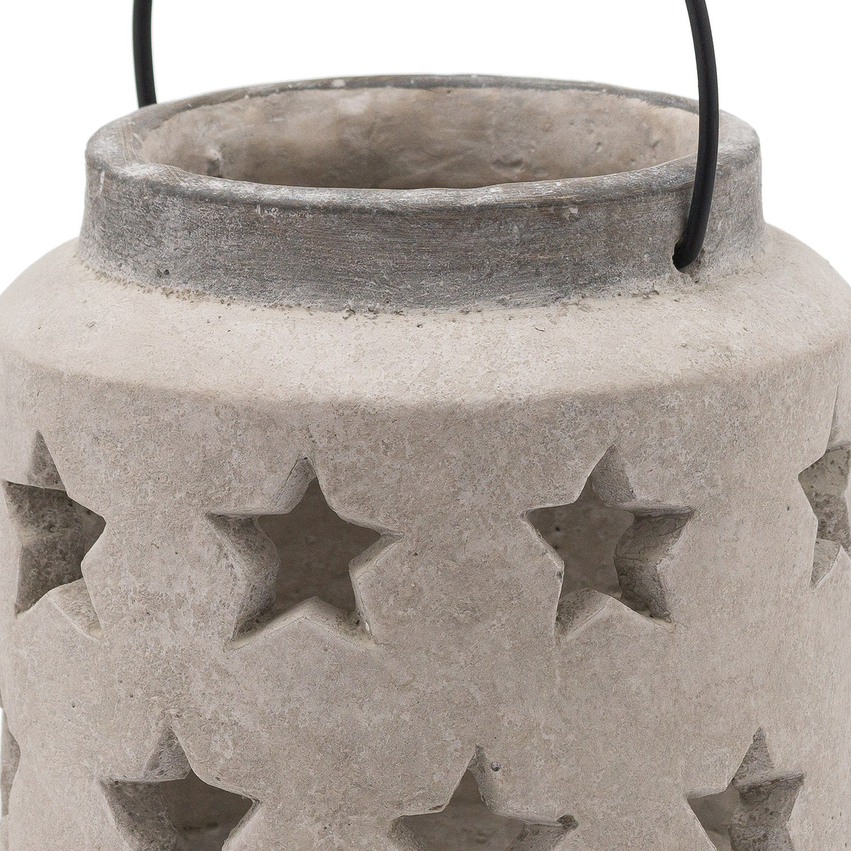 Close-up of the lantern's open neck, darker grey rim and star-shaped openings in the textured pale surface, with the sides of the black handle visible.