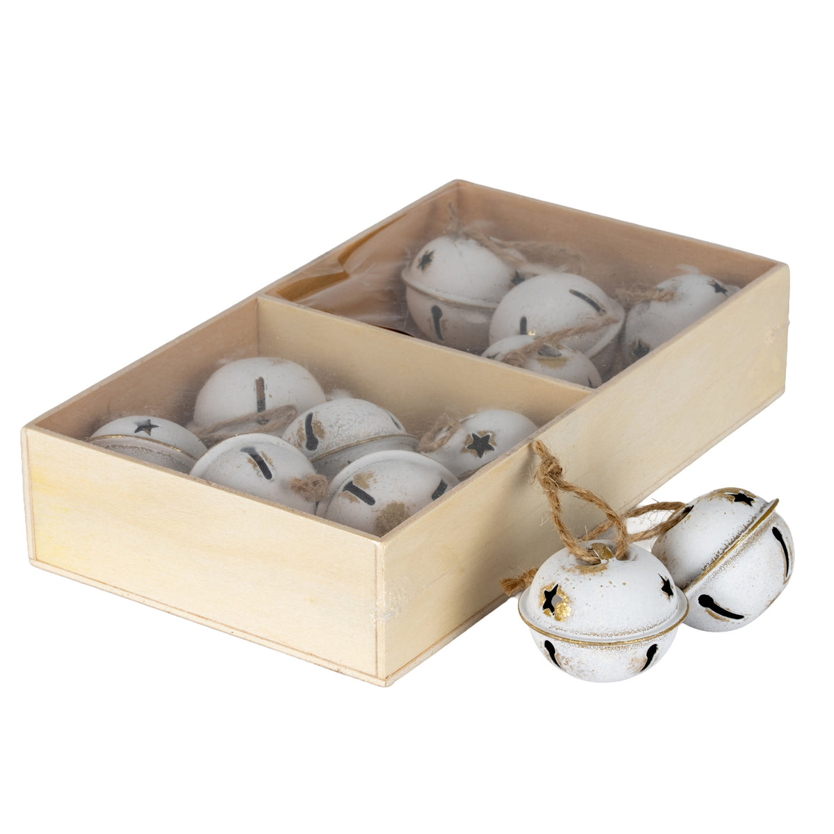 Angled view of cream-white bell ornaments in a divided pale-brown rectangular box, with two bells and their tan loops beside it.